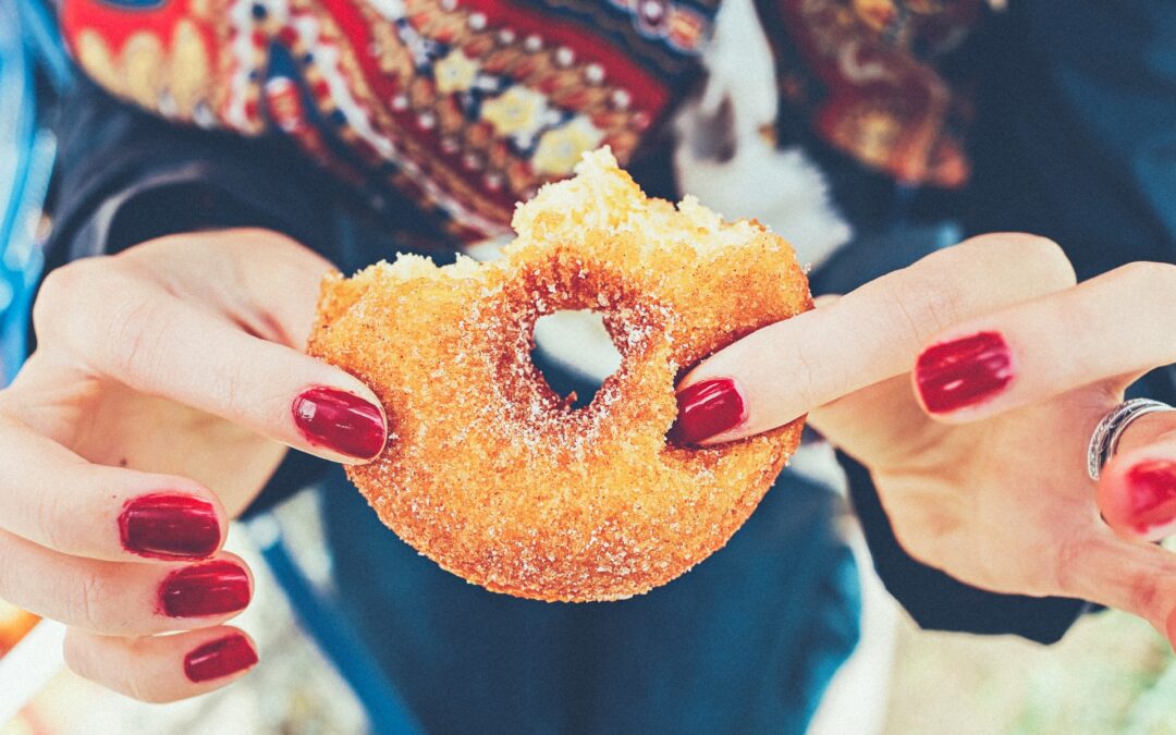 female hands holding donut